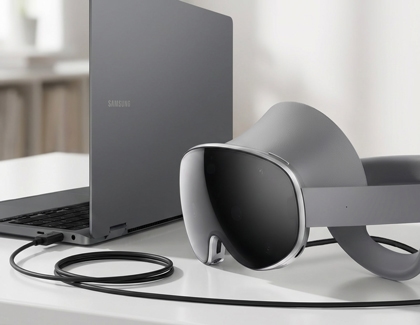 Galaxy XR headset connected to a Samsung laptop with a USB cable.