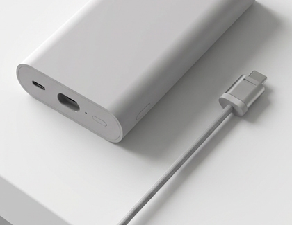 Charging cable placed next to the Galaxy XR battery pack.