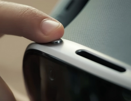 Close-up view of a finger pressing the top button on the Galaxy XR headset.