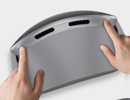 Hands pressing buttons on top of a Galaxy XR headset to power it off.
