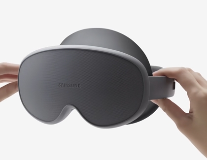 Hands placing the protective front cover back onto the Galaxy XR headset.