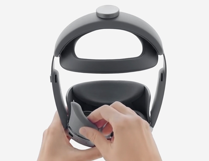 Hands removing the light shield from inside the Galaxy XR headset.