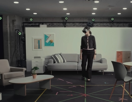 A person wearing Galaxy XR walking inside a tracked play area with floor markers.