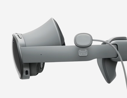 A close-up of the Galaxy XR headset showing the power cable detached from the side connector.