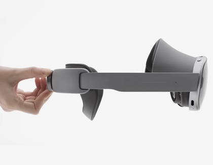 A hand holding the Galaxy XR headset by the rear fit dial to show normal movement in the headband.