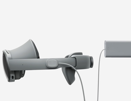 The Galaxy XR headset and battery pack shown with the charging cable aligned for connection.