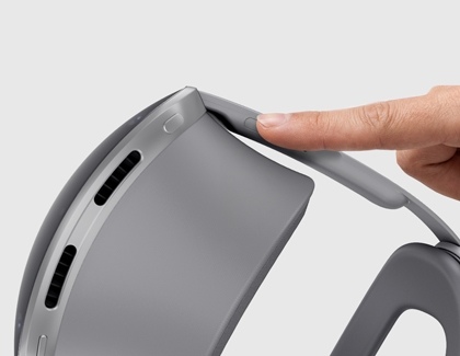 Galaxy XR headset with the USB port cover being lifted by a finger.