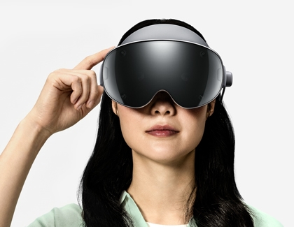 Woman tapping the Power button on the side of the Galaxy XR headset.