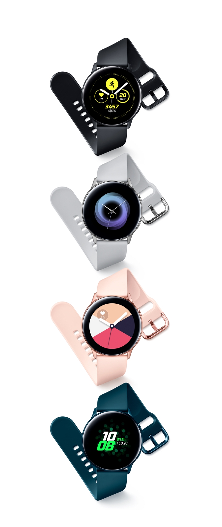 Two Galaxy Watch Actives upright and side-by-side with a black Wireless Charger Pad behind them. One watch has a black band, one has a rose gold band. Four Galaxy Watch Actives are upright and side-by-side. From left to right, one is black, one is silver, one is rose gold, and one is green.