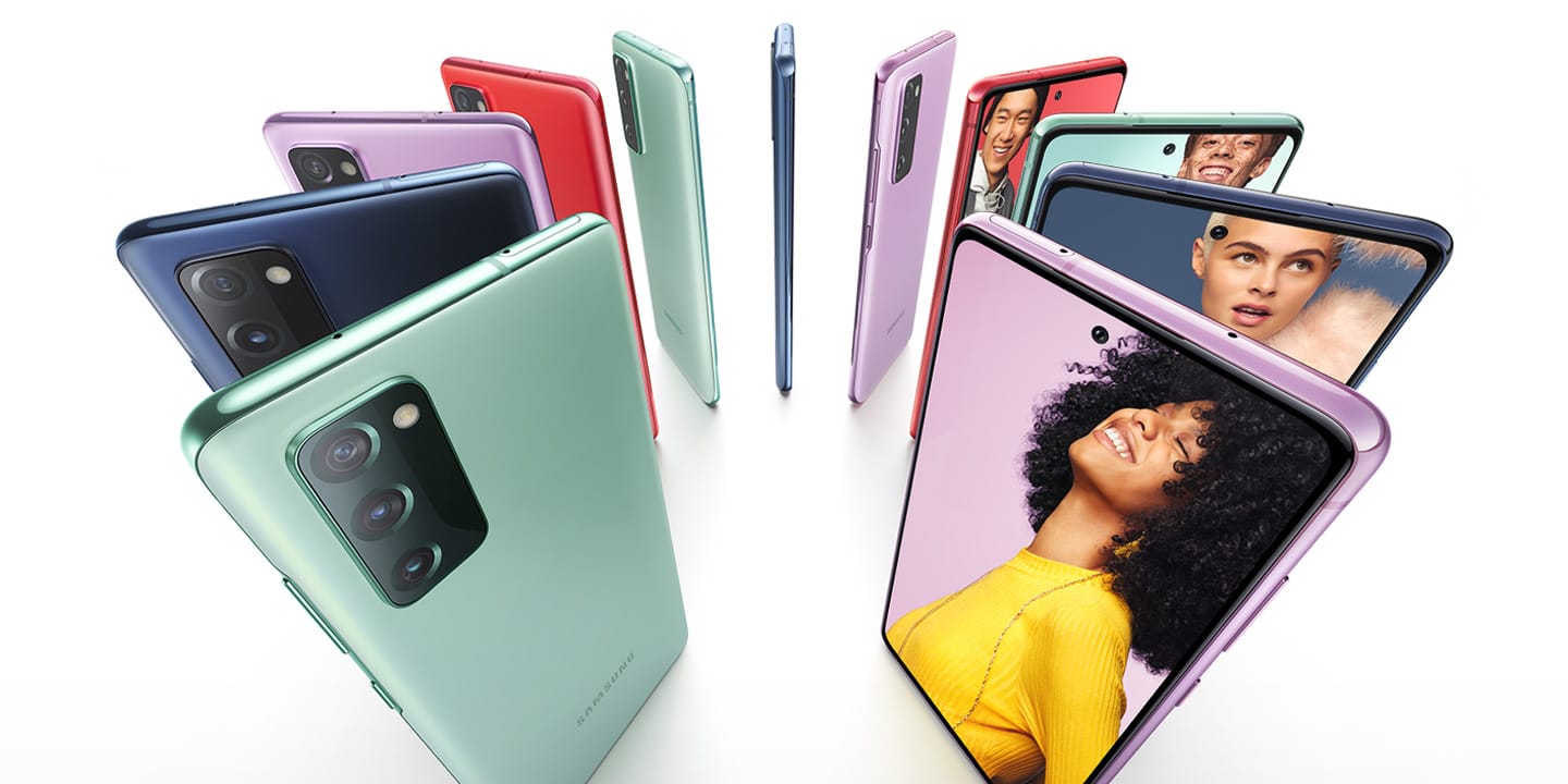 Eleven Galaxy S20 FE 5G phones standing upright in a circle, alternating Cloud Navy, Cloud Red, Cloud Lavender, and Cloud Mint. Some are seen from the rear and some are seen from the front, with photos of people onscreen. Each person stands against a color background that matches the color of the phone.