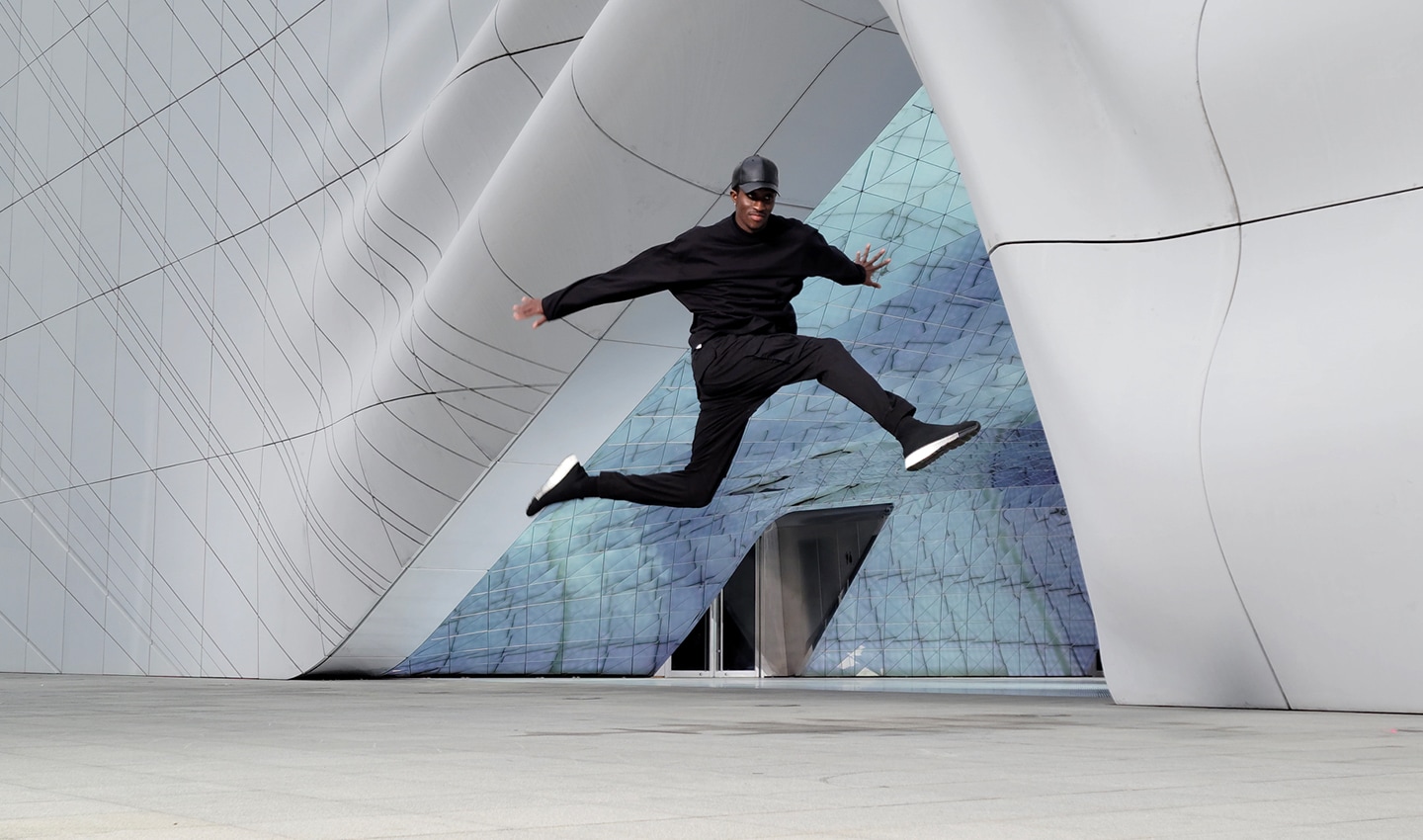Scene of a man dancing in front of an architectural structure, shot with 8K on Galaxy S21 Ultra 5G. A still image is taken from the video using 8K Video Snap. The image shows how crisp a frame from 8K video looks as a photo.