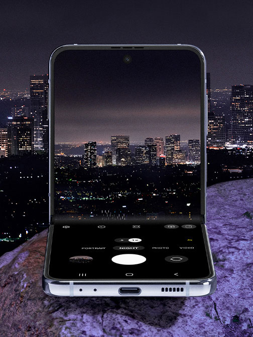 Galaxy Z Flip4 in Flex Mode. The camera is seen on the Main Screen in Night Mode. It is showing a …