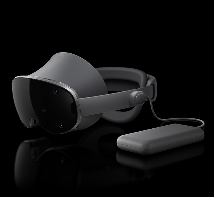 Galaxy XR is placed horizontally facing slightly left with the lightweight external battery pack placed next to the device and connected via the Power connector.
